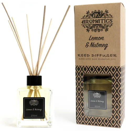 A "Lemon & Nutmeg" reed diffuser and its brown cardboard box displayed side-by-side on a white background. The diffuser bottle has a black label and wooden reeds.