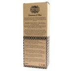 A detailed close-up of the back of the "Cinnamon & Clove" reed diffuser box. The surface shows a product description, instructions for use, and safety warnings printed in multiple languages.
