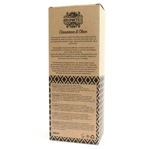 A detailed close-up of the back of the "Cinnamon & Clove" reed diffuser box. The surface shows a product description, instructions for use, and safety warnings printed in multiple languages.