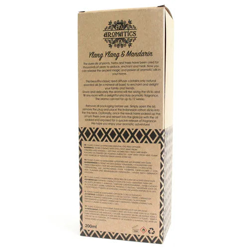 A detailed close-up of the back of the "Ylang Ylang & Mandarin" reed diffuser box. The surface shows a product description, instructions for use, and safety warnings printed in multiple languages.