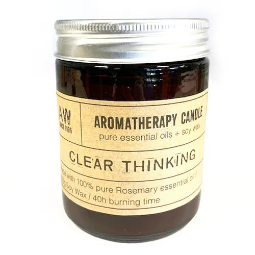 Aromatherapy candle in a dark glass jar with silver lid, labeled "Clear Thinking," made with pure rosemary essential oil and soy wax.