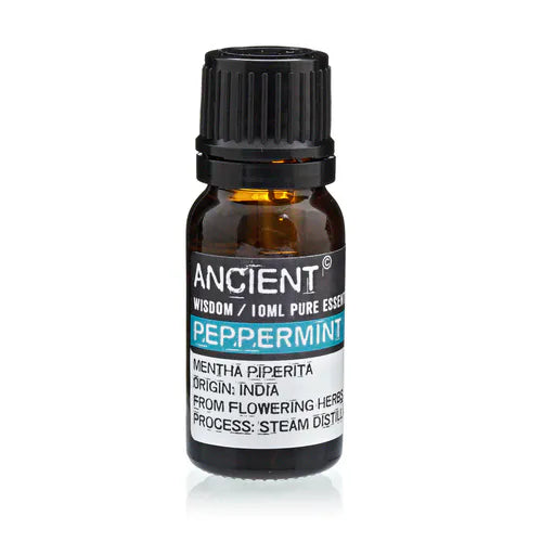 Amber glass bottle of Ancient Wisdom peppermint essential oil, labeled with origin from India and details about steam distillation from flowering herbs.