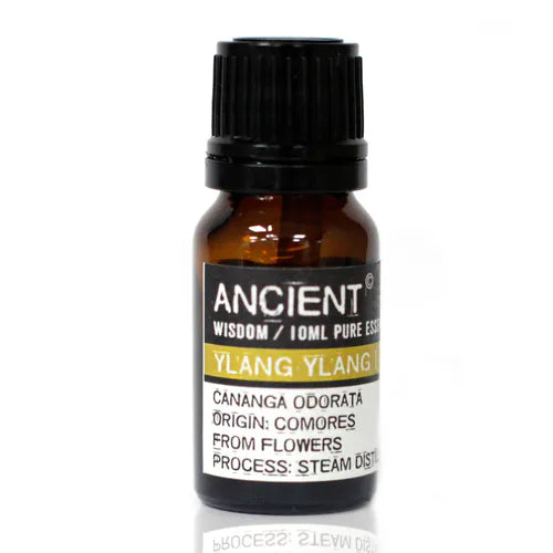 Amber glass bottle of Ancient Wisdom ylang ylang essential oil, labeled with origin from Comores and details about steam distillation from flowers.