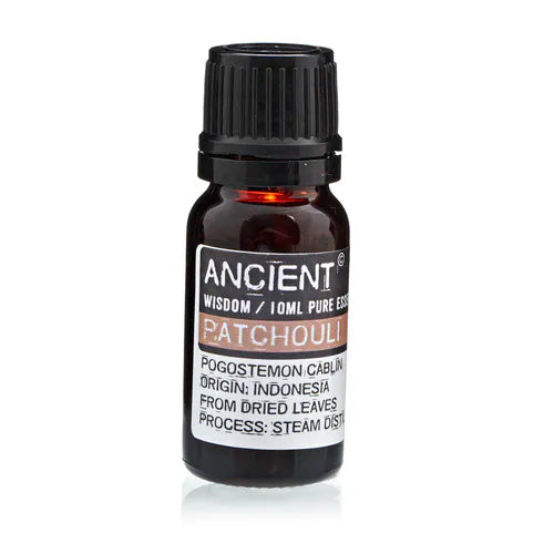 Amber glass bottle of Ancient Wisdom patchouli essential oil, labeled with origin from Indonesia and details about steam distillation from dried leaves.