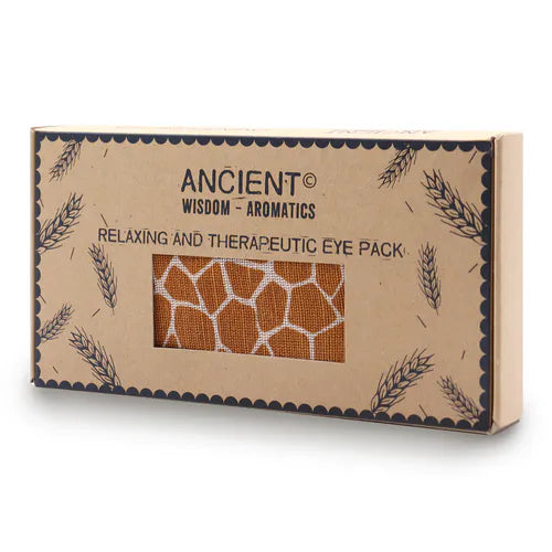 A close-up shot of a brown cardboard gift box for an aromatherapy eye pillow with a giraffe print pattern. The box is stamped with "Ancient Wisdom" and "Relaxing and Therapeutic Eye Pack," promoting a calming home fragrance and aromatherapy experience.