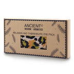 A straight-on shot of a brown gift box for an aromatherapy eye pillow. The box features a window that displays a green, yellow, and black leopard print, making it a stylish addition to any home fragrance or wellness product lineup.