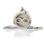 A close-up of a silver-colored essential oil necklace diffuser charm. The charm features a detailed "the infinity symbol wiht the word love" design, showcasing a blend of symbolic jewelry and functional aromatherapy.