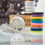 Stainless steel aromatherapy pendant necklace with a tree of life design, shown with colorful felt pads and lavender in the background.