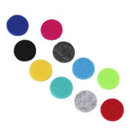 Set of colorful round felt pads in various colors including blue, pink, black, yellow, turquoise, gray, green, and red, used for essential oil diffuser jewelry.