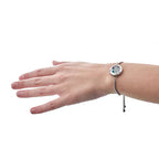 Stainless steel aromatherapy bracelet with tree of life design, worn on wrist.