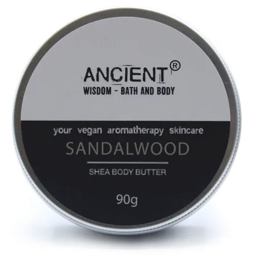 Round silver tin container of Ancient Wisdom Shea Body Butter, labeled “Sandalwood”, vegan aromatherapy skincare, 90g.