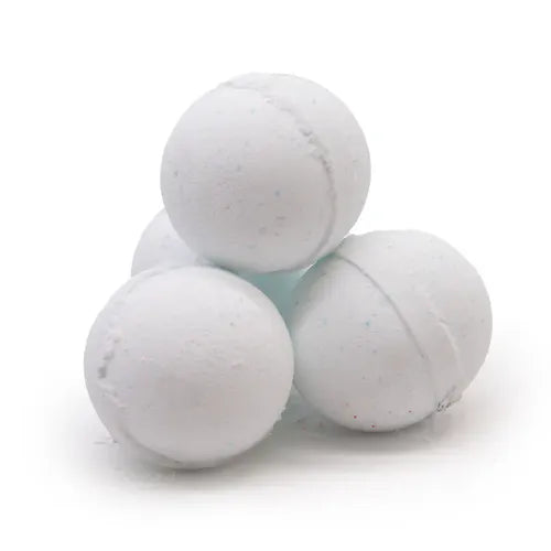 Four pale blue bath bombs stacked in a pyramid formation. Their smooth, rounded surfaces are lightly speckled with faint blue dots, giving them a cool and refreshing appearance. The texture suggests a fizzy, soothing release when placed in water.