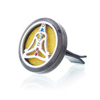 Elegant car aromatherapy diffuser clip in polished silver with a meditating figure design, featuring colorful gemstone accents representing chakras, with a bright yellow felt pad inside. A stylish accessory that brings balance, wellness, and a touch of luxury to your driving experience.
