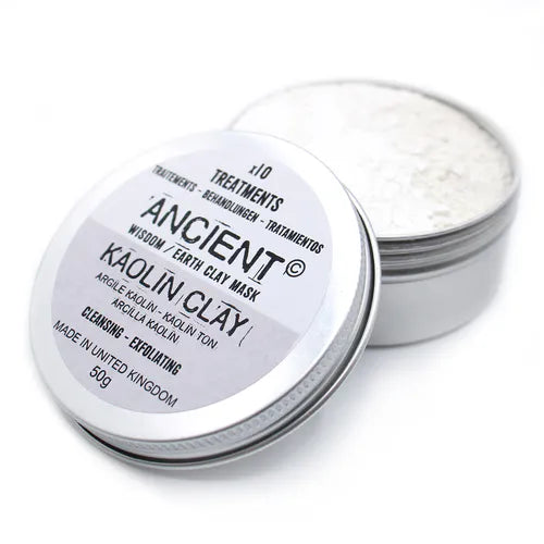 Open tin of Ancient Wisdom Earth Clay Mask with Kaolin Clay. The round silver metal container is shown with the lid tilted to the side, revealing the fine white clay powder inside. The label on the lid reads “x10 Treatments, Ancient Wisdom Earth Clay Mask, Kaolin Clay, Cleansing - Exfoliating, Made in United Kingdom, 50g” in bold black text with translations in French, German, and Spanish.