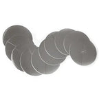 A set of multiple round silver-colored metal discs, each with a small pre-cut slit in the center. The discs are slightly reflective and arranged in an overlapping curved line, showing their thin, flat design. They are intended as protective inserts for ear candles, preventing wax or ash from falling onto the skin.
