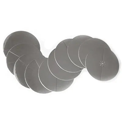 A set of multiple round silver-colored metal discs, each with a small pre-cut slit in the center. The discs are slightly reflective and arranged in an overlapping curved line, showing their thin, flat design. They are intended as protective inserts for ear candles, preventing wax or ash from falling onto the skin.