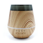 Front view of a wood grain aroma diffuser with a rounded, modern design, a dark semi-transparent top lid, and four small buttons labeled ON, 1H, 3H, and 6H at the base.