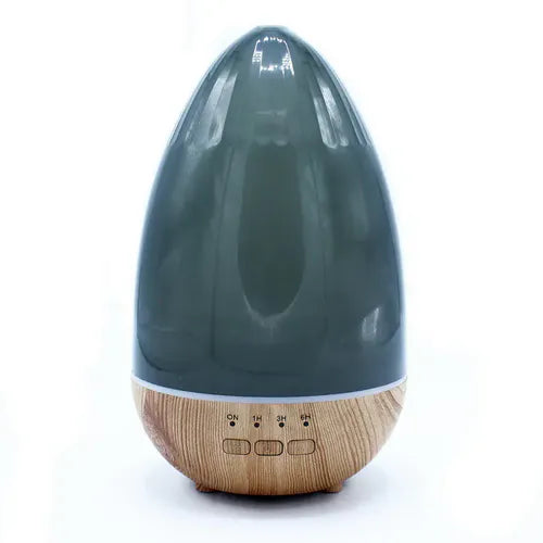 Front view of a teardrop-shaped aroma diffuser with a wooden base and dark transparent top, featuring three buttons (ON, 1H, 3H, 6H) at the base.