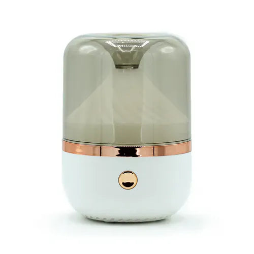 Close-up front view of a white round mirror aromatherapy humidifier with a transparent top and rose gold accent.