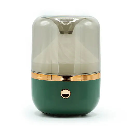 Close-up of a green and gold round mirror aromatherapy humidifier with a smoky transparent top and a single golden button on the front.
