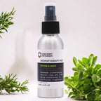 Bottle of Ancient Wisdom Aromatherapy Mist "Thyme & Mint," 100ml, placed with fresh green thyme and mint leaves around it, emphasizing natural herbal ingredients.