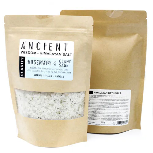 Brown kraft pouch of Ancient Wisdom Himalayan Bath Salt Rosemary & Clary Sage, clarity blend infused with essential oils, olive oil, and rosemary herb; pale salt with small green herbal fragments visible.