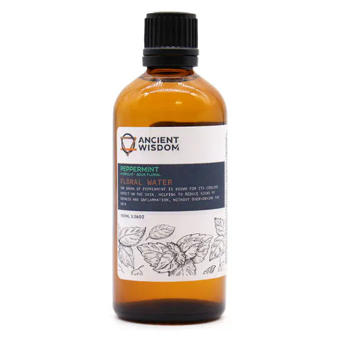 Amber glass bottle of Ancient Wisdom Peppermint Floral Water (100ml) with illustrated peppermint leaves on the label, known for its cooling and refreshing properties for the skin.