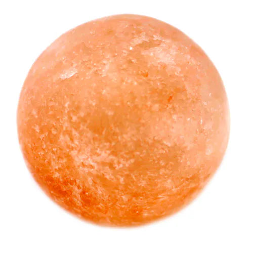 Round Himalayan pink salt deodorant stone isolated on white background.