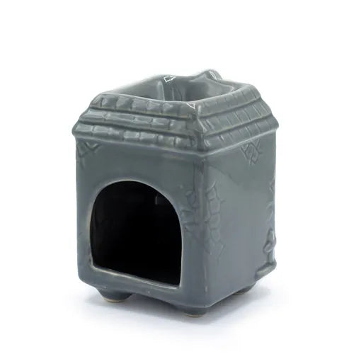 Rear view of the grey ceramic house-shaped oil burner, showing a large arched opening at the back for inserting a tealight candle.