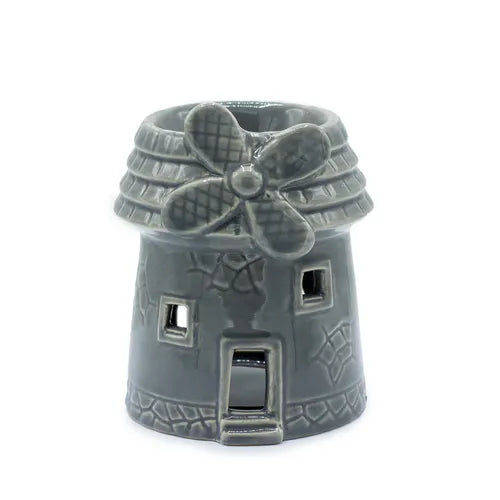 Gray ceramic oil burner shaped like a windmill tower, featuring a textured brick pattern, rectangular cut-out door and windows, and a large decorative propeller with four blades attached to the front. The round base tapers slightly upward, and the top has an open bowl for holding oils or wax melts.
