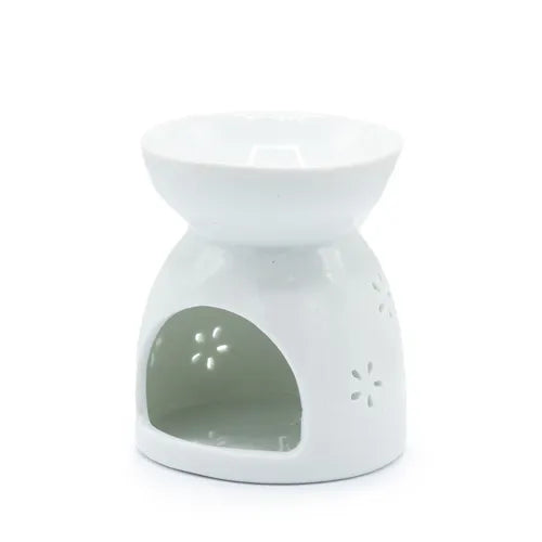 Rear view white ceramic oil burner with a wide shallow bowl on top and a large open cavity at the front, decorated with small perforated floral patterns on the sides.