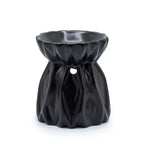 Black ceramic oil burner with a unique draped fabric-like texture, featuring a wide rounded bowl at the top and a small circular cutout in the center of the body for ventilation. The surface has a smooth, glossy finish, creating the appearance of flowing folds.