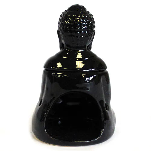 Glossy black ceramic Buddha-shaped oil burner viewed from the back, with a hollow opening at the base for a tealight candle. The piece has a detachable head that forms the upper part of the sculpture, showing curled hair texture on the head.