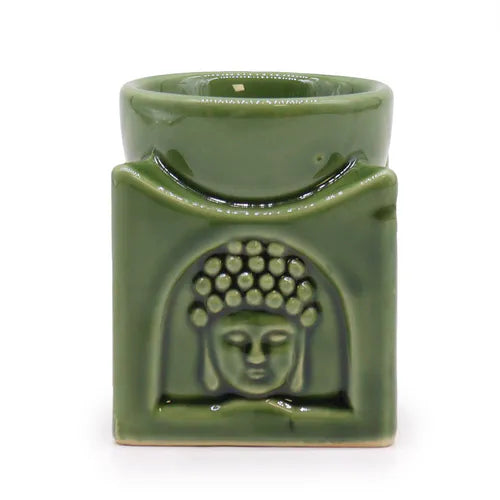 Green ceramic oil burner with square design, featuring a detailed Buddha face carved on the front. The burner has a circular dish at the top for essential oils or wax melts, and a hollow section below for placing a tealight candle, making it ideal for aromatherapy use.
