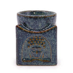Artistic ceramic oil diffuser in blue mottled glaze with embossed Buddha face motif, designed for home fragrance, relaxation, and spiritual ambiance.