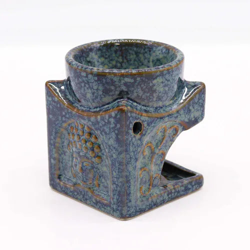 Handmade ceramic oil burner with speckled blue glaze, featuring embossed Buddha head design and decorative patterns, ideal for aromatherapy and meditation spaces.