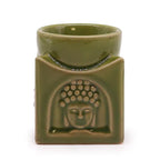 Front view of a green ceramic Buddha oil burner with embossed Buddha head motif, handcrafted design for aromatherapy, incense, and home spa ambiance.