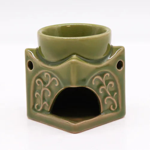 Back view of a green ceramic Buddha oil burner with arched opening for tealight candle placement, decorated with embossed swirls, ideal for essential oils and incense.