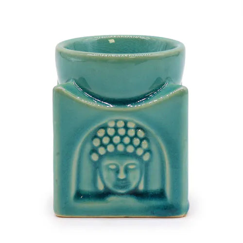Square turquoise ceramic aroma lamp with embossed Buddha face design, smooth glazed finish, and a recessed bowl for holding essential oils or wax melts.