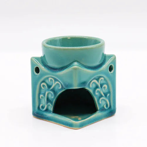 Rear view of a turquoise ceramic Buddha oil burner with decorative vine patterns and a large opening to place a tealight candle.