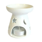 A compact, white ceramic oil and wax melt warmer with a star and moon cutout design. essential oil diffuser features a wide top dish for wax or oil and a base with an arched opening to insert a tea light candle. A tea light is shown inside, demonstrating how the cutouts create a celestial glow. The product is photographed against a clean white background. This elegant oil burner is ideal for aromatherapy, creating a cozy ambiance