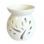 A beautiful, white ceramic oil warmer with a glossy finish, featuring a detailed cutout of a tree with leaves on its side. This stylish, modern aromatherapy essential oil diffuser has a top bowl for holding wax melts or oils and a base with a large opening to accommodate a tea light candle. The intricate tree design allows the candle's light to cast elegant shadows, creating a tranquil and relaxing ambiance. This product is ideal for home decor, meditation, and gifting.Shot against a clean white background.