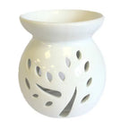 A beautiful, white ceramic oil warmer with a glossy finish, featuring a detailed cutout of a tree with leaves on its side. This stylish, modern aromatherapy essential oil diffuser has a top bowl for holding wax melts or oils and a base with a large opening to accommodate a tea light candle. The intricate tree design allows the candle's light to cast elegant shadows, creating a tranquil and relaxing ambiance. This product is ideal for home decor, meditation, and gifting.Shot against a clean white background.