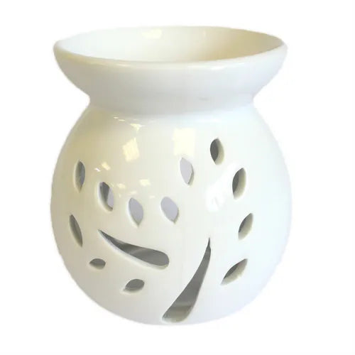 A beautiful, white ceramic oil warmer with a glossy finish, featuring a detailed cutout of a tree with leaves on its side. This stylish, modern aromatherapy essential oil diffuser has a top bowl for holding wax melts or oils and a base with a large opening to accommodate a tea light candle. The intricate tree design allows the candle's light to cast elegant shadows, creating a tranquil and relaxing ambiance. This product is ideal for home decor, meditation, and gifting.Shot against a clean white background.