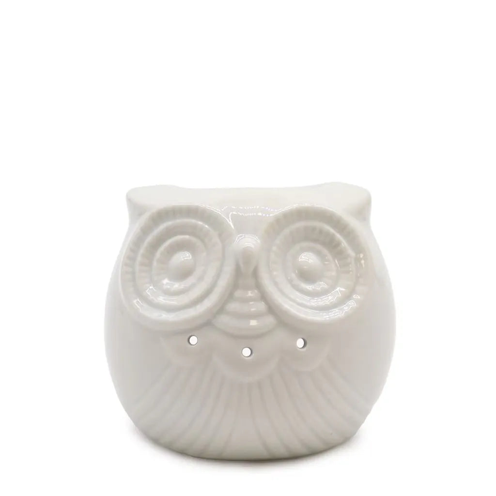 A white, glossy ceramic owl oil burner with a rounded, plump body and a textured feather pattern. The owl has large, circular, textured eyes with small cutouts below them for ventilation and light. The top of the owl's head serves as a bowl for essential oils or wax melts. The product is displayed on a white background.
