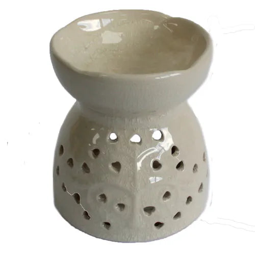 A rustic, crackle-glazed off-white ceramic oil burner with a subtle, distressed finish. The base is decorated with a cutout tree of life pattern with heart-shaped leaves, while the top bowl has a classic crackle texture and smooth interior. This essential oil diffuser is perfect for a shabby-chic or bohemian home aesthetic and is designed for use with wax melts or fragrance oils. The product is photographed against a clean white background.