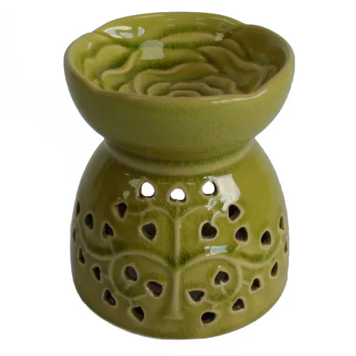A charming, glossy green ceramic oil burner with a crackle glaze texture. The top of the burner has a raised rose pattern inside the bowl, and the base is adorned with a cutout tree of life motif with heart-shaped leaves. This essential oil and wax melt warmer is perfect for creating a relaxing and fragrant atmosphere. The product is photographed against a clean white background.