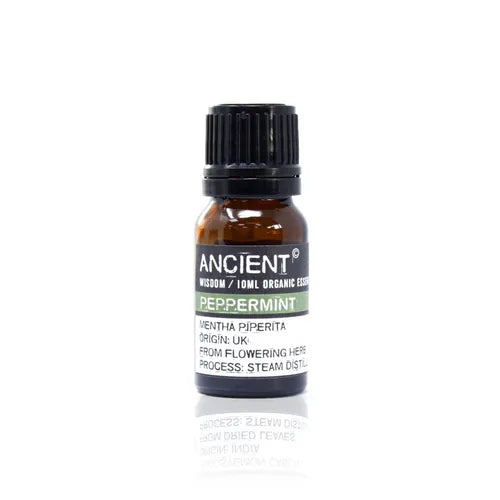 A small, 10ml amber glass bottle of Ancient Wisdom Organic Peppermint essential oil. The bottle has a black cap and a black label with a light green band. The label lists product details including the Latin name, origin, and distillation process. The bottle is photographed against a clean white background.