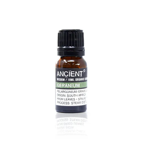 A small, 10ml amber glass bottle of Ancient Wisdom Organic Geranium essential oil. The bottle has a black cap and a black label with a light green band. The label lists product details including the Latin name, origin, and distillation process. The bottle is photographed against a clean white background.