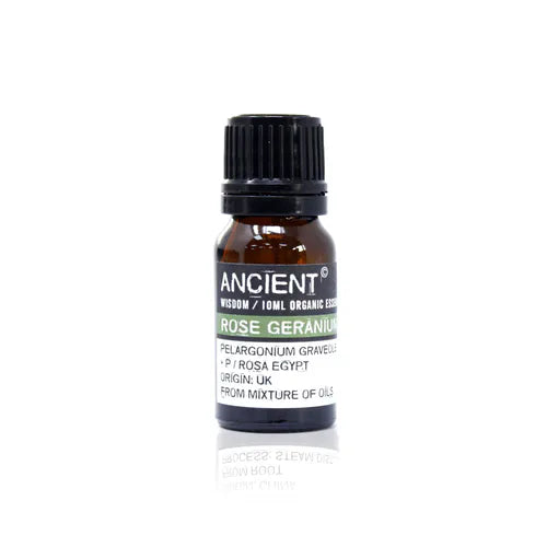A small, 10ml amber glass bottle of Ancient Wisdom Organic Rose Geranium essential oil. The bottle has a black cap and a black label with a light green band. The label lists product details including the Latin name, origin, and distillation process. The bottle is photographed against a clean white background.